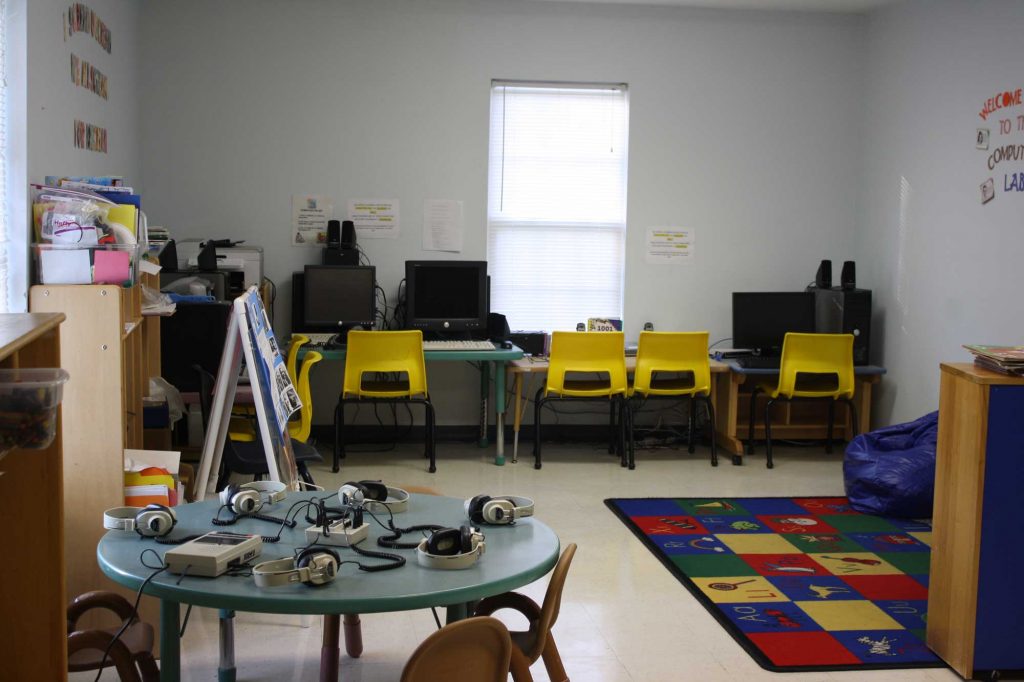 A view of the Kid Appeal Learning Center computer lab, with headphones placed on a table