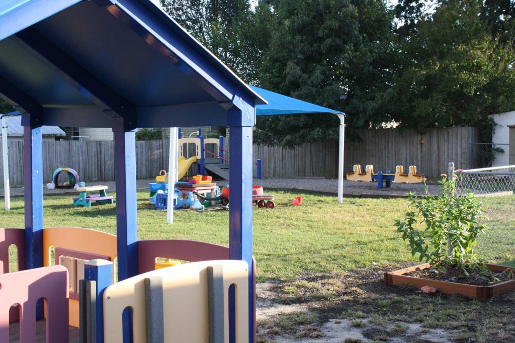 A toddler playground with colorful equipment such as slides, swings, and climbing structures